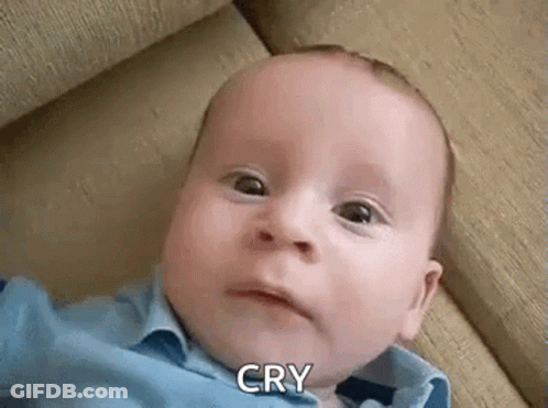 Crying Baby With Funny Face On Couch GIF