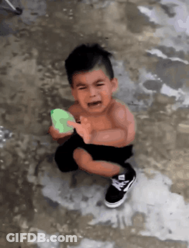 Crying Little Boy Holding Green Object GIF