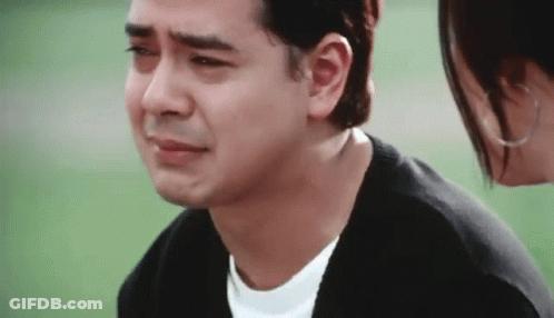 Crying Man Standing Next To A Woman Looking At Him GIF