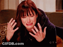 Crying Woman On Couch Hands On Face GIF