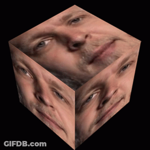 Cube With Man's Face On Black Background GIF