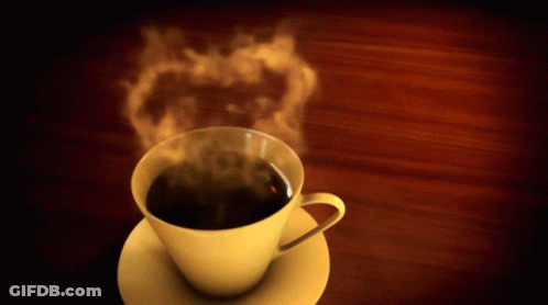 Cup Of Steaming Coffee On Saucer On Wooden Table GIF