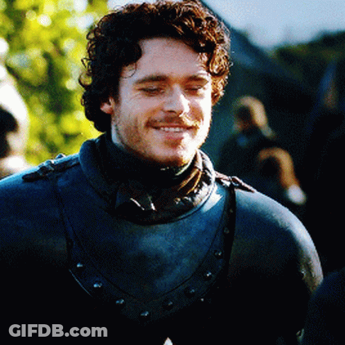 Curly Bearded Man In Armor And Scarf GIF