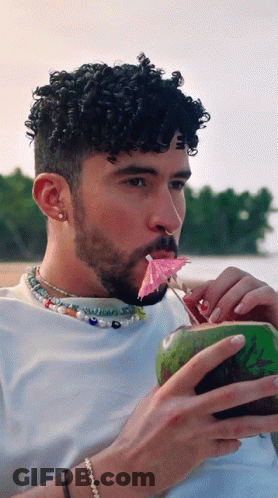 Curly Hair Man Drinking Coconut Pink Umbrella In Mouth GIF