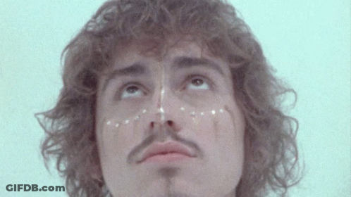 Curly Hair Man With Mustache And White Dots GIF