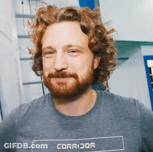 Curly Haired Bearded Man In Gray Corridor Shirt GIF