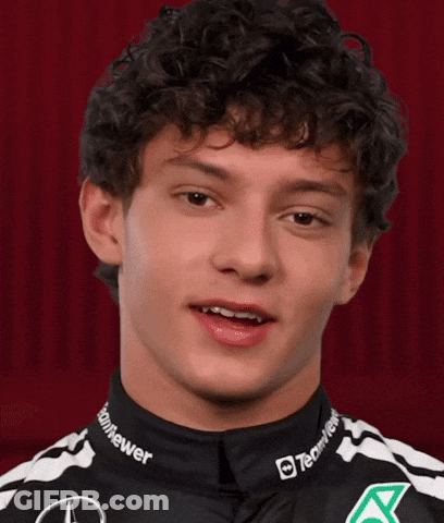 Curly Haired Man In Black And White Shirt Says Some Nice GIF