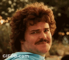 Curly Haired Man In Blue Shirt Making Funny Face GIF