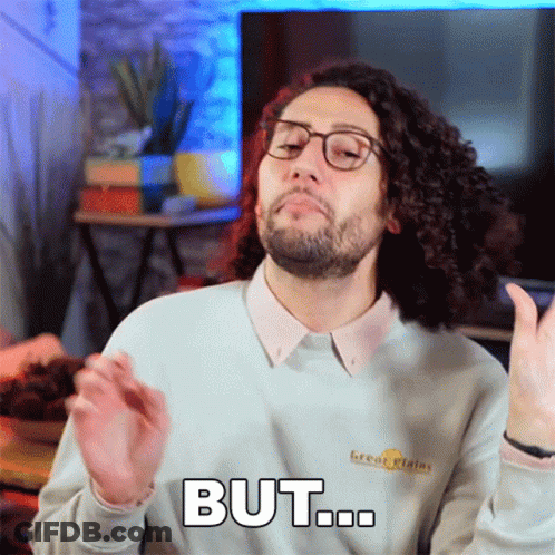 Curly Haired Man In Glasses And Sweater Saying But GIF