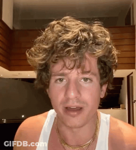 Curly Haired Man In White Tank Top And Gold Necklace GIF