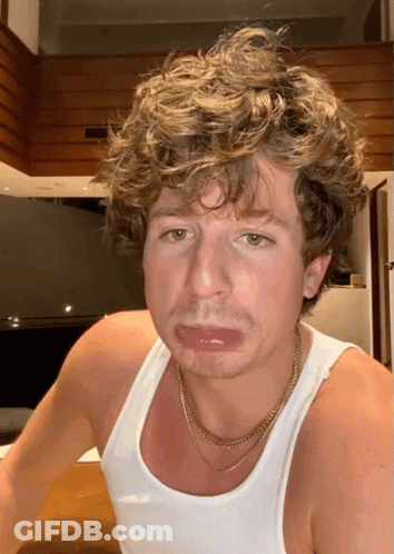 Curly Haired Man In White Tank Top With Gold Chain GIF