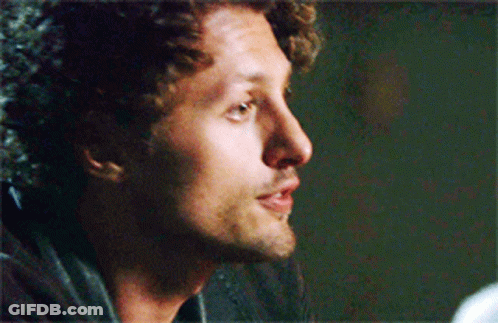 Curly Haired Man With Beard Looking To Side GIF