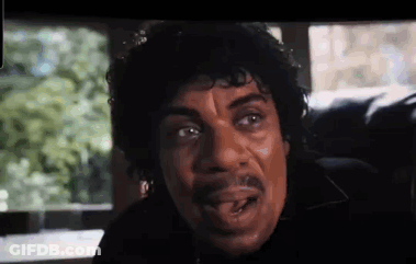 Curly Haired Man With Mustache Looking At Camera GIF