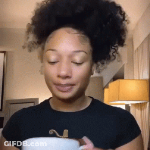 Curly-Haired Woman Holding Coffee Making Funny Face GIF