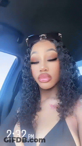 Curly Haired Woman In Back Seat Wearing Sunglasses GIF