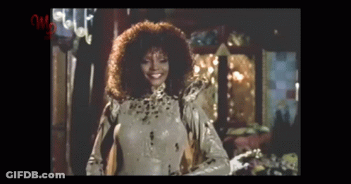 Curly Haired Woman In Leopard Print Costume GIF