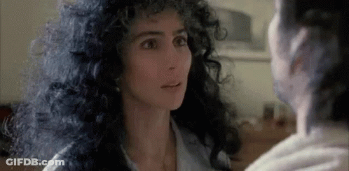 Curly-Haired Woman Looking At Another Woman GIF