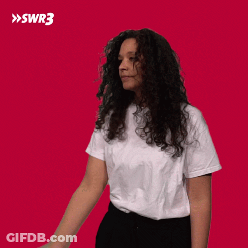 Curly-Haired Woman White T-Shirt Black Pants Red SWR3 GIF