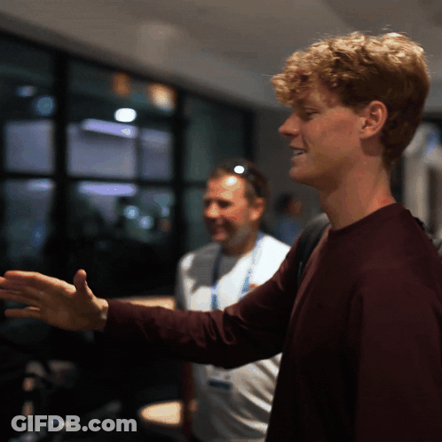 Curly Haired Young Man In Dark Room GIF
