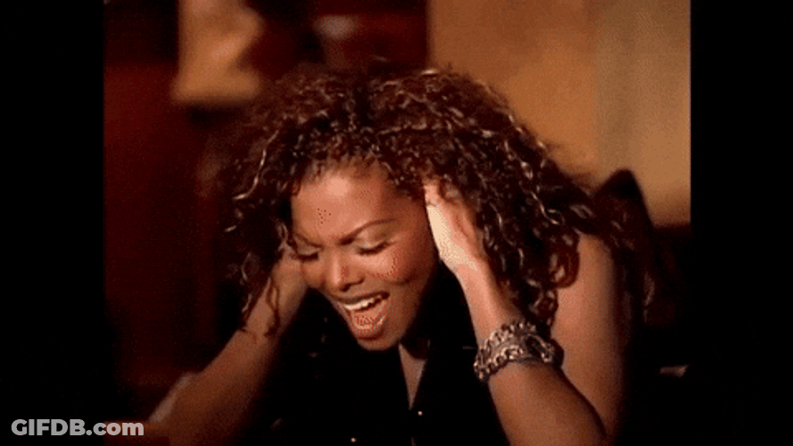Curly Woman Ear Plugs While Singing GIF