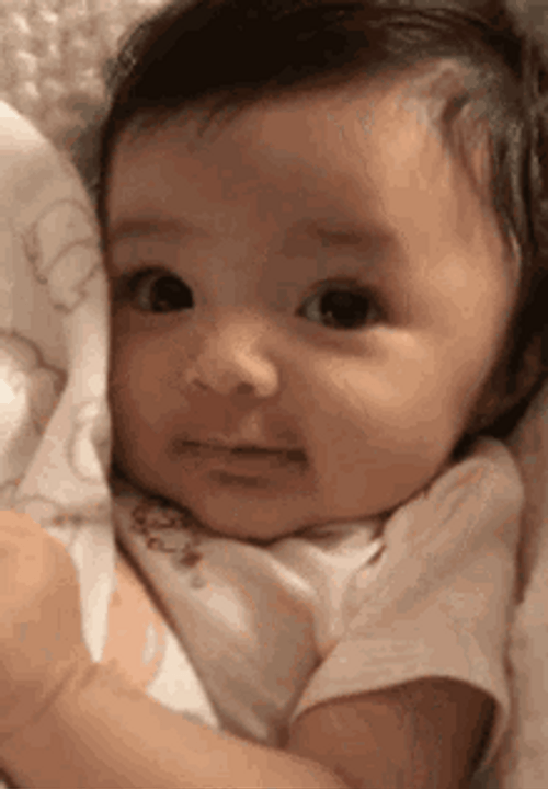 Cute Baby Lying Shy Smile GIF