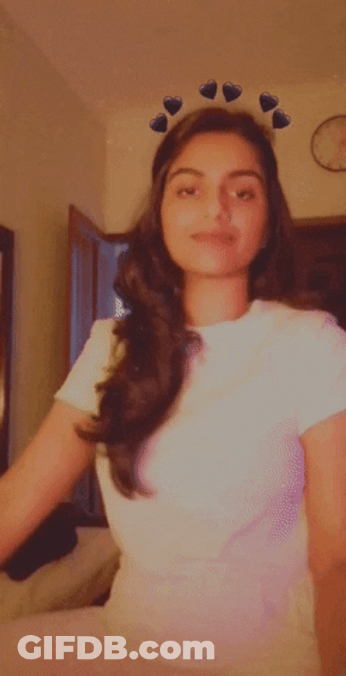 Cute Girl Smiles With Black Hearts GIF