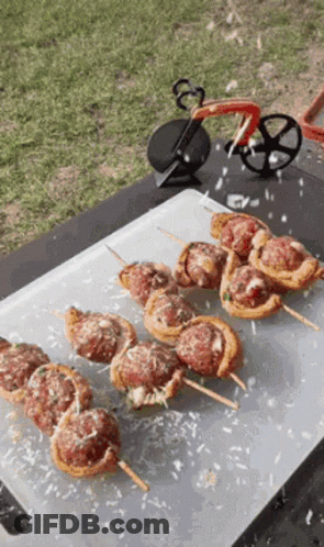 Cutting Board With Meatball Skewers And Pizza Cutter GIF