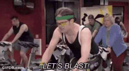 Cyclists On Track With Smiley Face On Head GIF