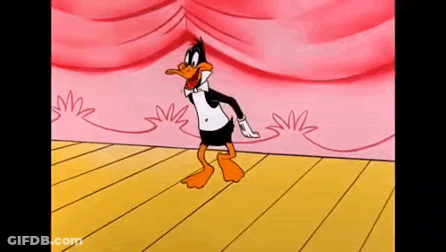 Daffy Duck Is Dancing On A Stage With A Pink Curtain Behind Him . GIF