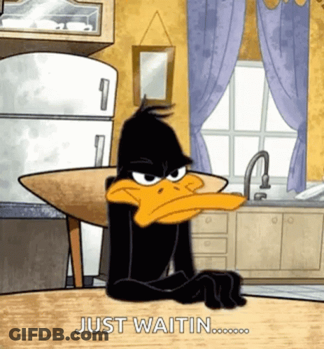 Daffy Duck Sitting At Table Waiting GIF