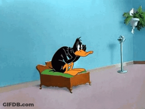 Daffy Duck Sitting On Couch With Fan GIF