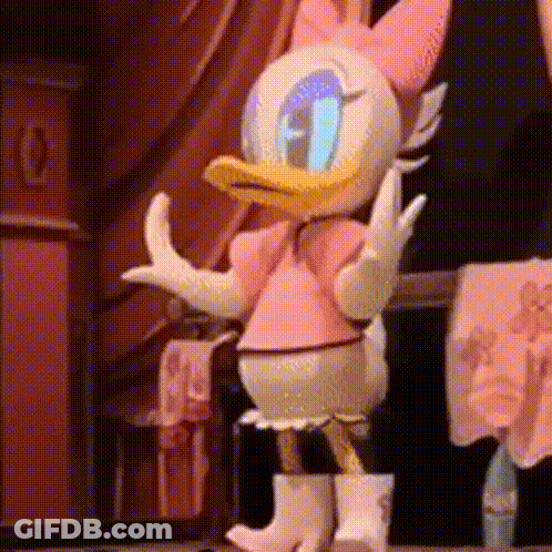 Daisy Duck Is Wearing A Pink Dress And White Boots While Dancing On A Stage . GIF