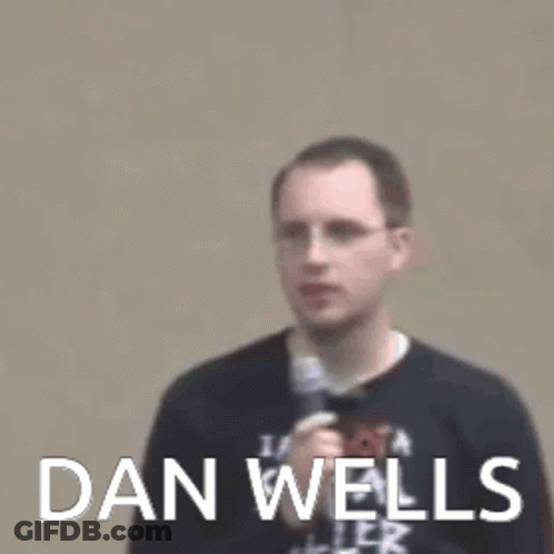 Dan Wells Is Sitting In Front Of A Window GIF