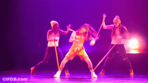 Dancers Performing On Stage With Purple Lighting GIF