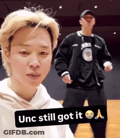 Dancing Man In Black Jacket Next To Man In White Hoodie GIF