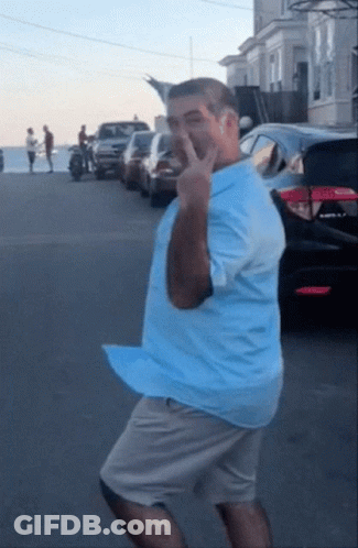 Dancing Man In Blue Shirt And Khaki Shorts GIF