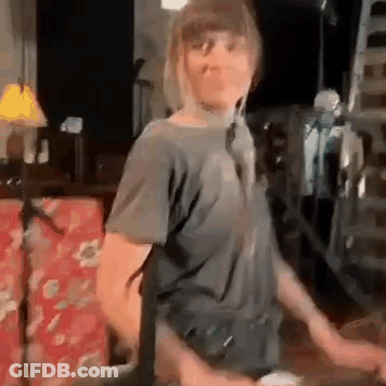 Dancing Woman With Microphone And Red Couch GIF