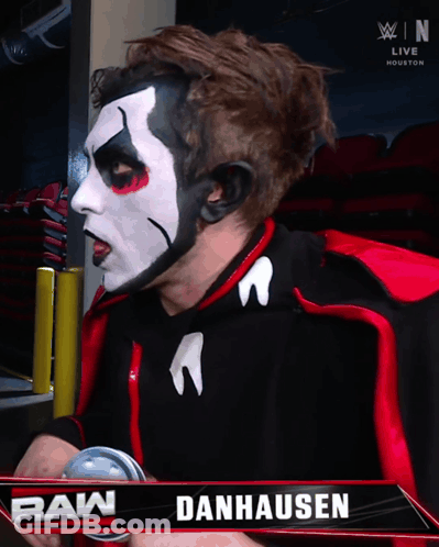 Danhausen Wrestler In Front Of Raw Sign GIF