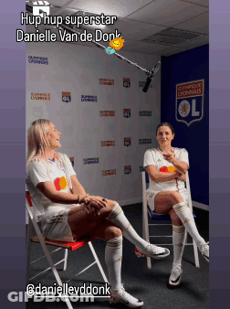 Danielle Van De Donk Sits In A Chair With A Microphone In Front Of A Wall That Says Olympique Lyonnais GIF