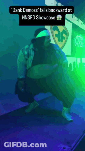 Dank Demoss Falls Backward At NNSFD Showcase Purple Background GIF