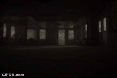 Dark Room With Carpeted Floor And Staircase GIF