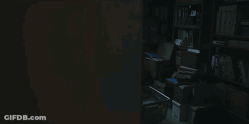 Dark Room With Typewriter And Calculator On Desk GIF