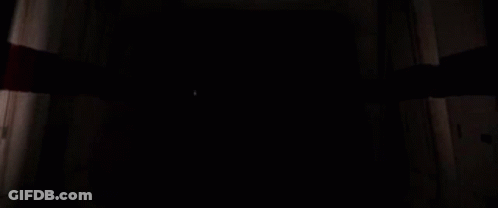 Darth Vader Is Holding A Red Lightsaber In The Dark . GIF