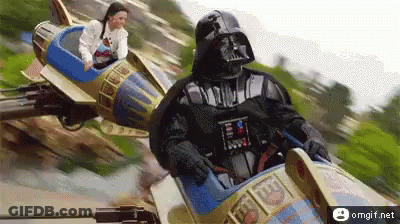 Darth Vader Is Riding A Roller Coaster With A Woman Sitting On It GIF