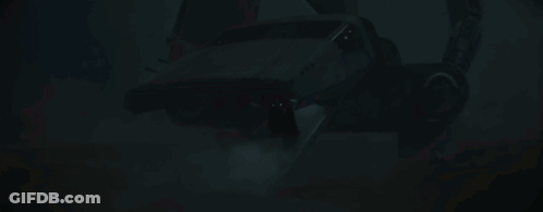 Darth Vader Is Standing In A Dark Room With A Red Light Behind Him . GIF