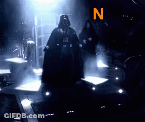 Darth Vader Is Standing In A Dark Room With The Letter N Behind Him GIF