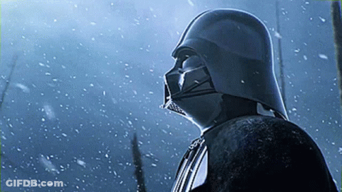 Darth Vader Is Standing In The Snow Wearing His Helmet GIF