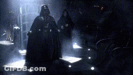 Darth Vader Is Walking In A Dark Room With A Group Of People GIF