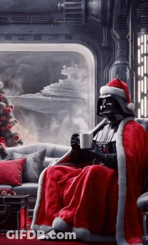Darth Vader Is Wearing A Santa Hat And Sitting On A Couch GIF