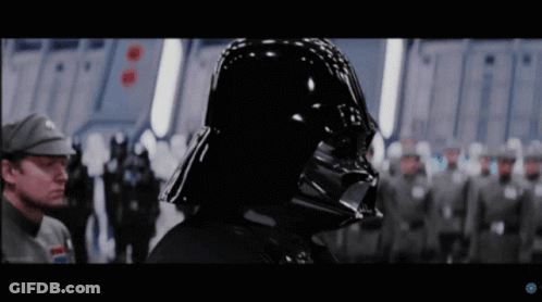 Darth Vader Stands In Front Of A Group Of Soldiers In A Star Wars Movie GIF